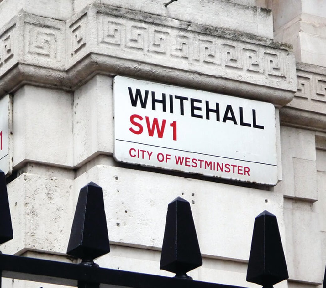 Shot of a building with street sign for Whitehall, SW1, City of Westminster