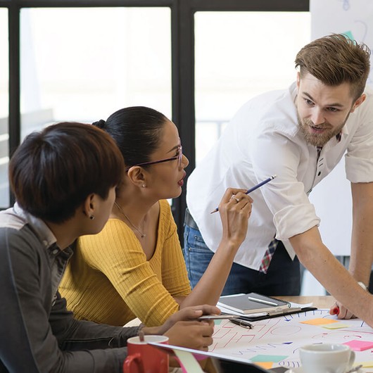 Four employees conducting a workshop in a meeting room