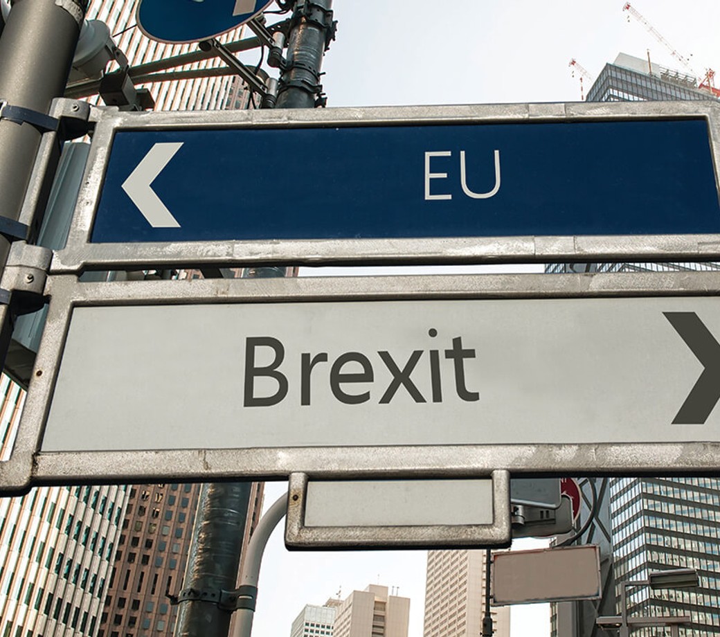 City streets with direction signs showing EU to the left and Brexit to the right